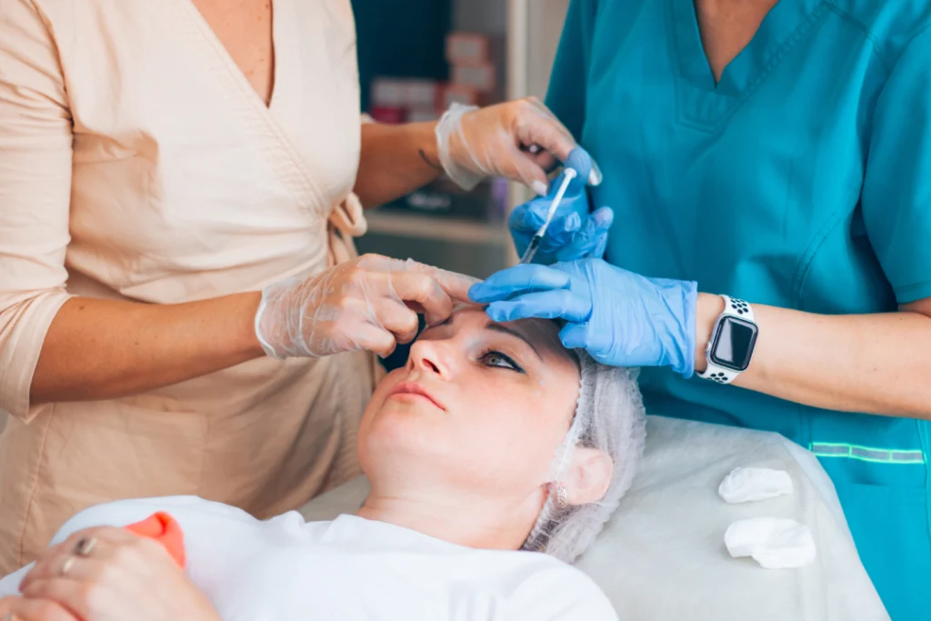 A professional administering a Botox injection during a cosmetic procedure.