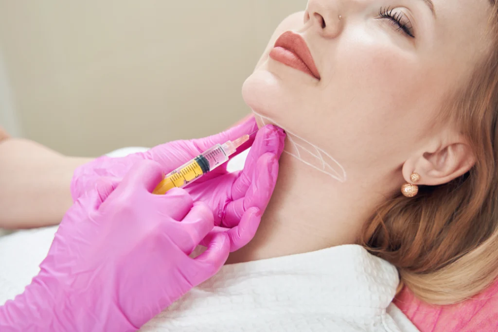 A professional administering a Dysport injection to a patient’s neck area, targeting wrinkles and improving skin texture.