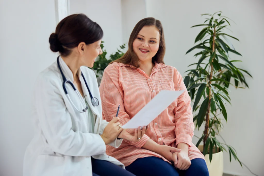 A doctor consulting with a patient about a liposculpting procedure.