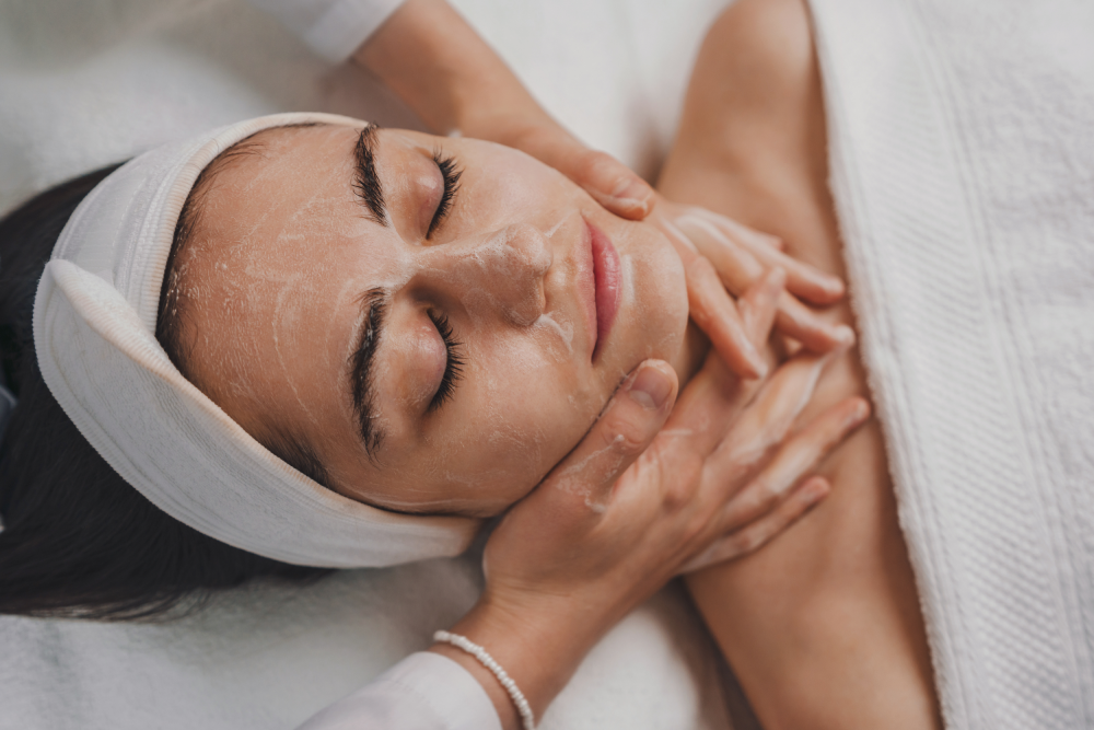 Woman enjoying a soothing hydrafacial treatment at a medspa.
